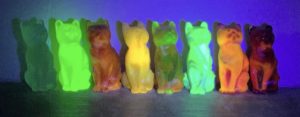 UV reactive Mosser cats under a black light