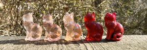 Red and pink Mosser Glass sitting cats